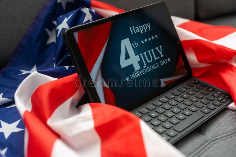 American flag and digital tablet on table
