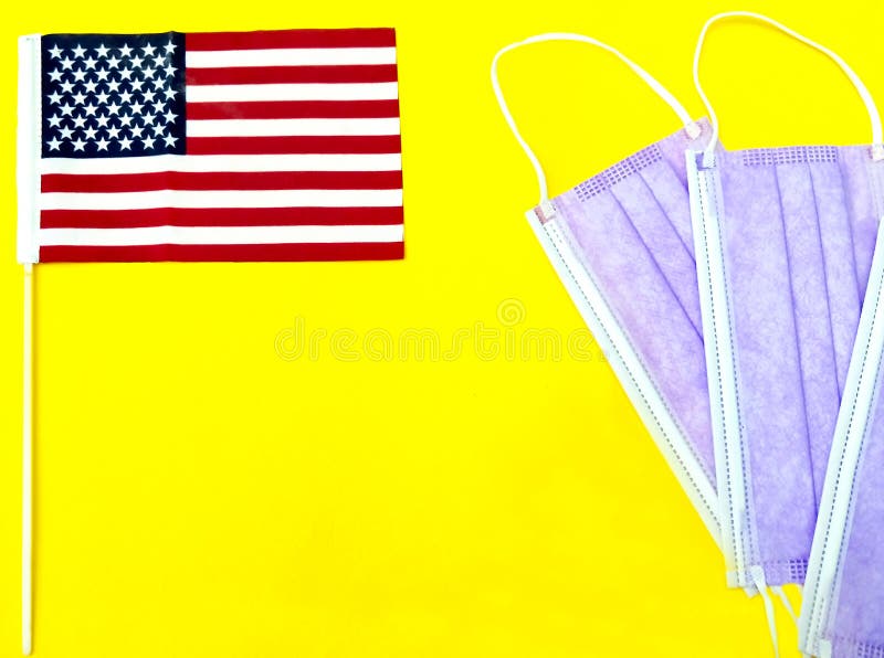 American Flag and Face Masks Against Bright Yellow Background Stock ...