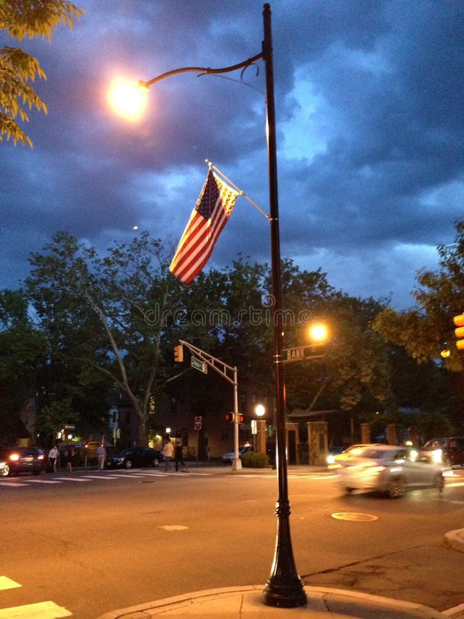 American Flag Hangs from Lamppost at Dusk Stock Image - Image of hangs ...
