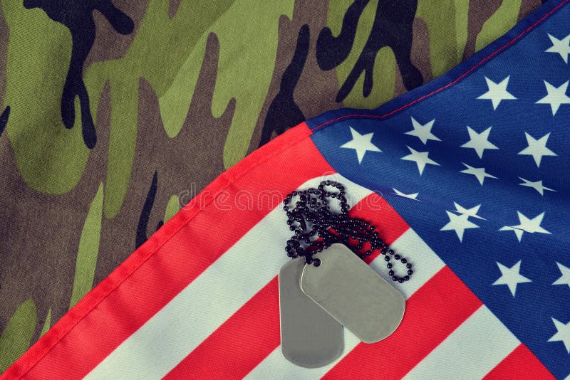 American flag and soldiers badges on camouflage fabric. stock photo American flag and soldiers badges on camouflage fabric. stock photo