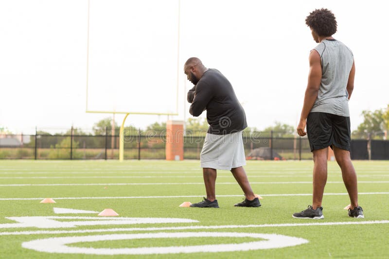 American Football Coach Training a Young Athlete. Stock Photo - Image ...