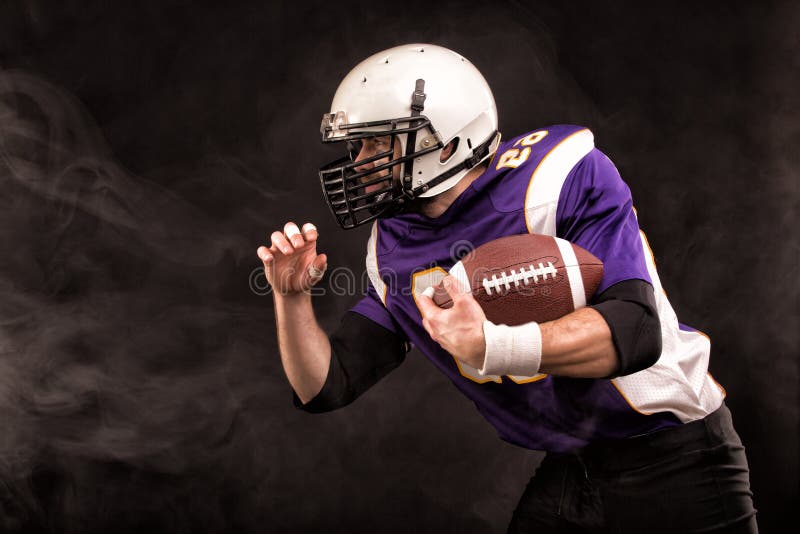 Американский футбол мотивация. American Football Player holding the Ball with one hand. Hold players