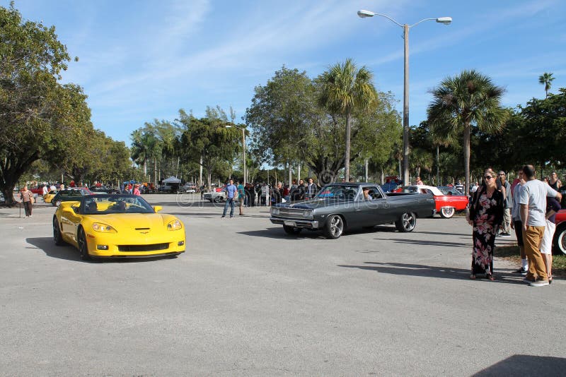 Driving along road. American muscle cars driven outdoors on a sunny day.