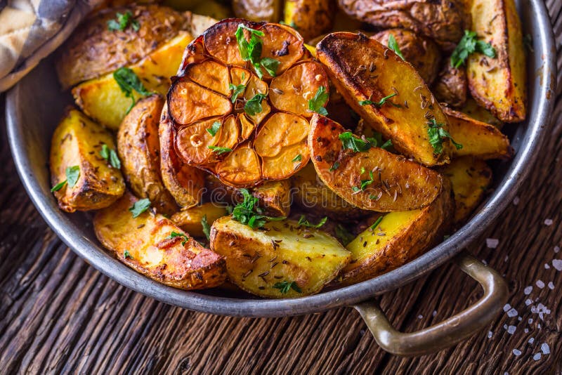 American potatoes. Baked potatoes in peel. Roasted potatoes with garlic spices salt cumin and herbs