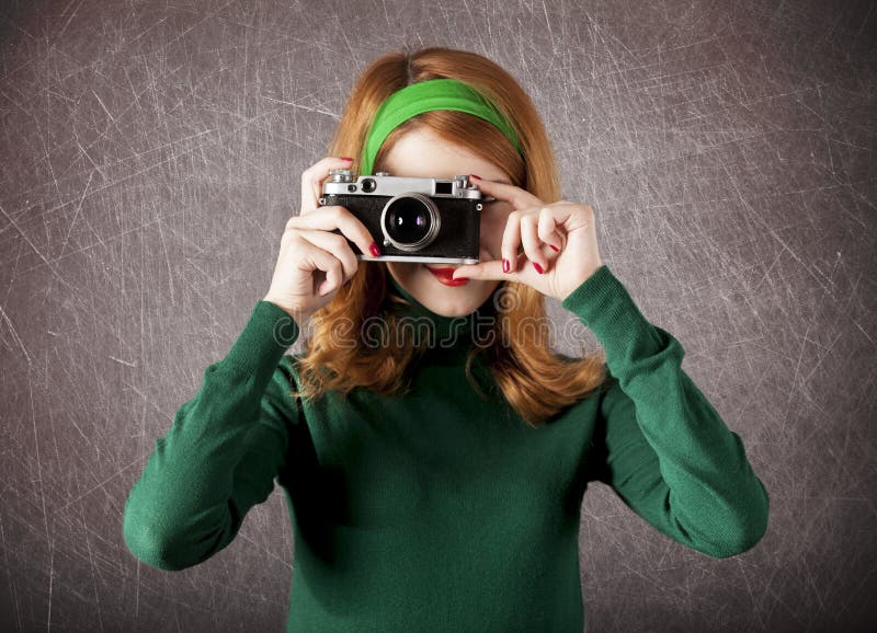 American redhead girl with camera.