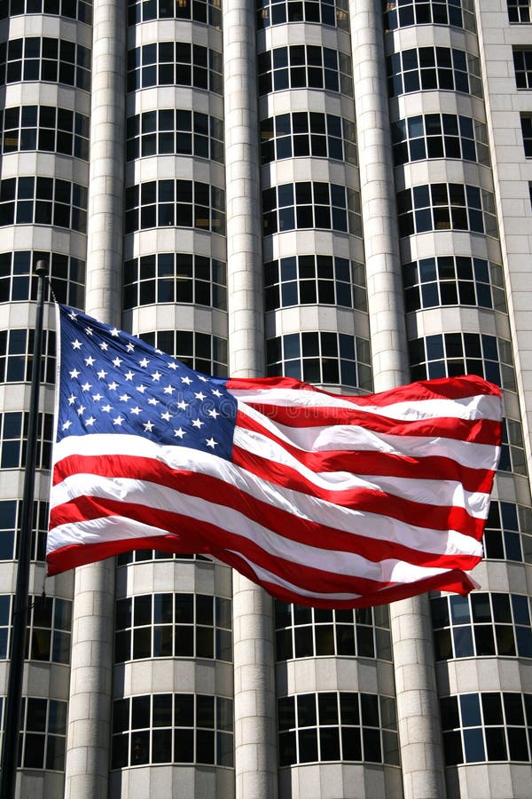 USA flag with business building as a backdrop. USA flag with business building as a backdrop