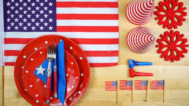 American theme party table overhead with flags, party hats, plates and cutlery