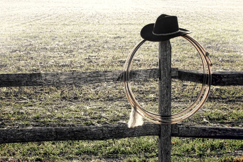 American West Rodeo Cowboy Hat and Lasso on Fence