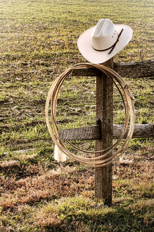 American West Rodeo Cowboy Hat and Lasso on Fence