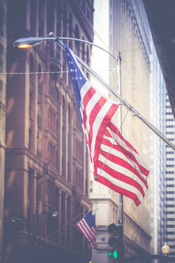 American flag waving in the breeze in the Chicago downtown loop business district. American flag waving in the breeze in the Chicago downtown loop business district