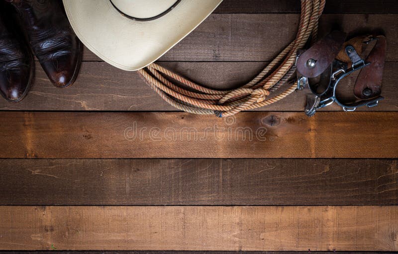 Amerikanischer Cowboy Items incluing Sporne eines Lassos und ein traditioneller Strohhut auf einem hölzernen Plankenhintergrund lizenzfreie stockfotografie Amerikanischer Cowboy Items incluing Sporne eines Lassos und ein traditioneller Strohhut auf einem hölzernen Plankenhintergrund lizenzfreie stockfotografie