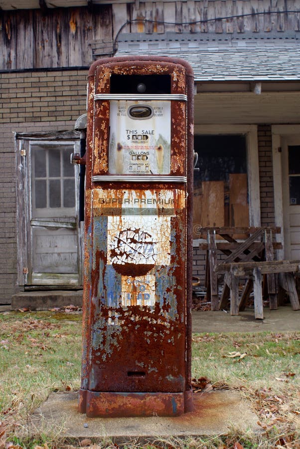 Antique American gas pump. Rusted and with chipped off paint in front of a old brick building. Antique American gas pump. Rusted and with chipped off paint in front of a old brick building.