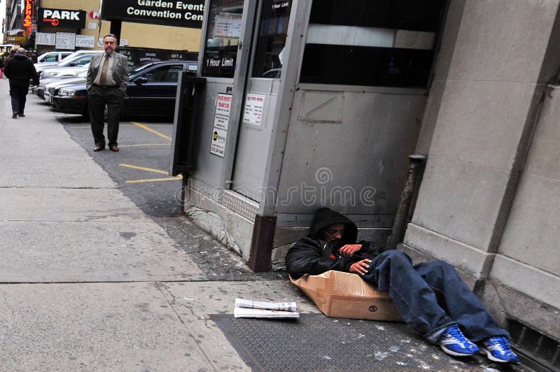 NEW YORK CITY - NOV 11: A homeless man sleeps on the streets Nov 11, 2009 in New York, New York.A 2013 report show that the number of homeless people recorded in NYC topped 50,000 for the first time. NEW YORK CITY - NOV 11: A homeless man sleeps on the streets Nov 11, 2009 in New York, New York.A 2013 report show that the number of homeless people recorded in NYC topped 50,000 for the first time.