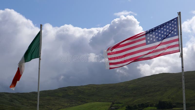 Amerikanska och irländska flaggor som viftar på landsbygden