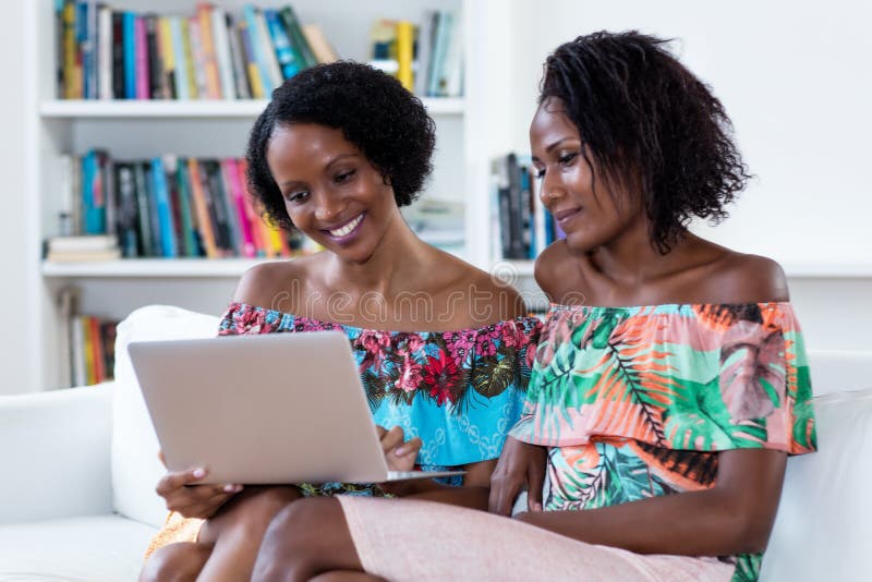 African american women shopping online with computer at home. African american women shopping online with computer at home