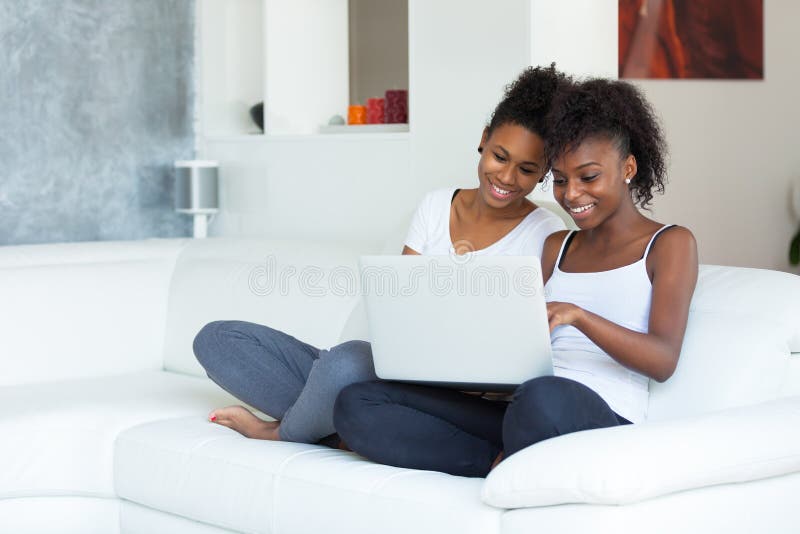 African American student girls using a laptop computer - black people. African American student girls using a laptop computer - black people