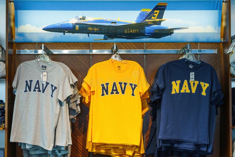 ANNAPOLIS,MARYLAND,USA - JUNE 01,2022: US Navy T-shirts for sale in souvenir shop at United States Naval Academy in Annapolis,Maryland,USA. ANNAPOLIS,MARYLAND,USA - JUNE 01,2022: US Navy T-shirts for sale in souvenir shop at United States Naval Academy in Annapolis,Maryland,USA.