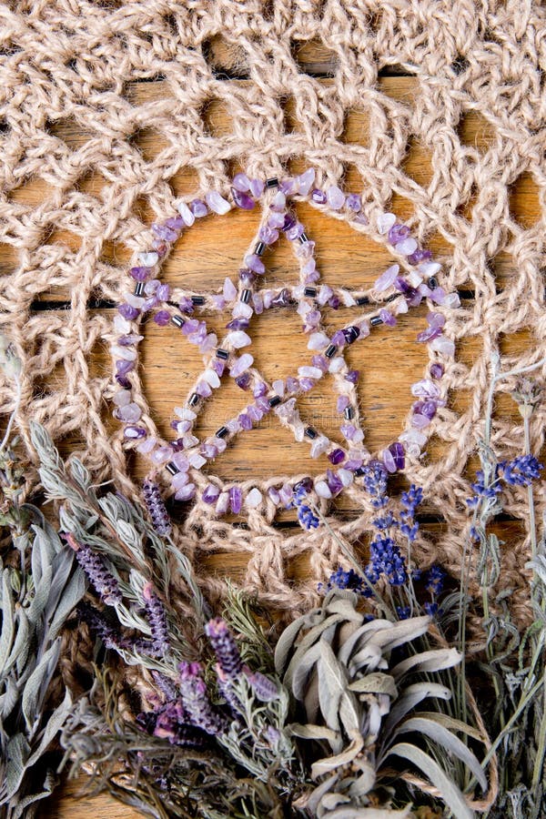 Amethyst Pentagram with dried herb bundles on rustic crotchet jute altar cloth