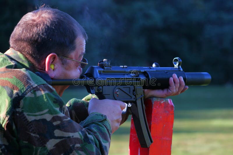 Firing a silenced machine gun. Firing a silenced machine gun