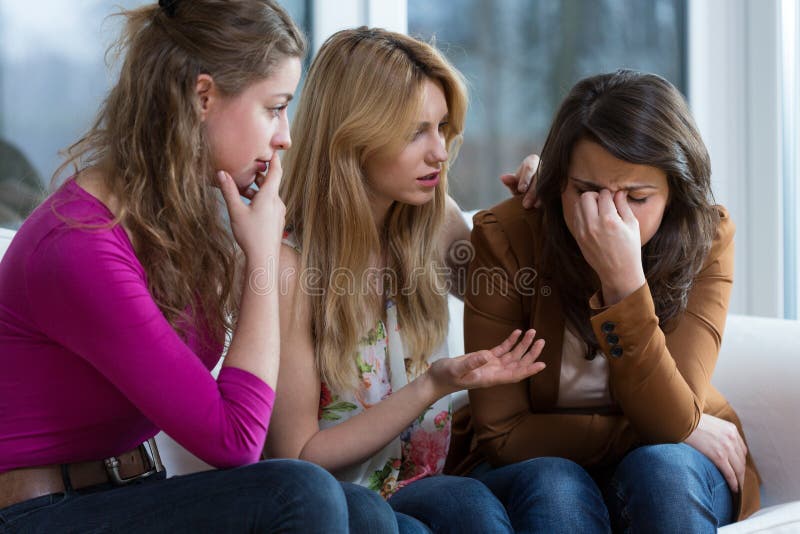 Two young worried girls supporting crying friend. Two young worried girls supporting crying friend