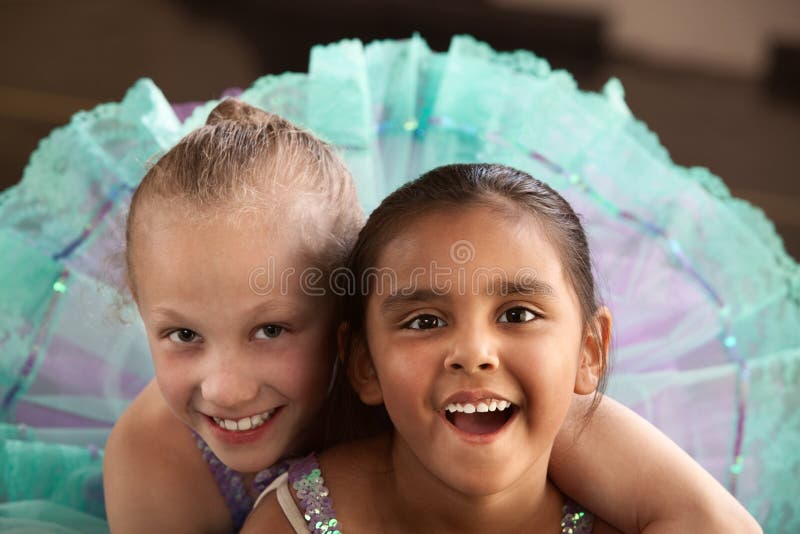 Two little ballet students hugging each other. Two little ballet students hugging each other