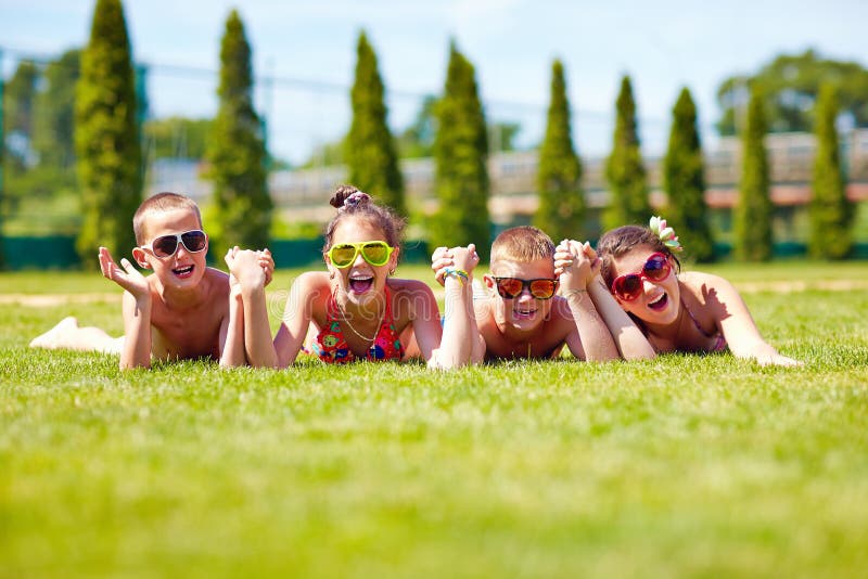 Group of happy teenage friends having fun lying on summer lawn. Group of happy teenage friends having fun lying on summer lawn