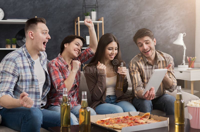 Amigos felizes que usam a tabuleta em casa fotos de stock Amigos felizes que usam a tabuleta em casa fotos de stock