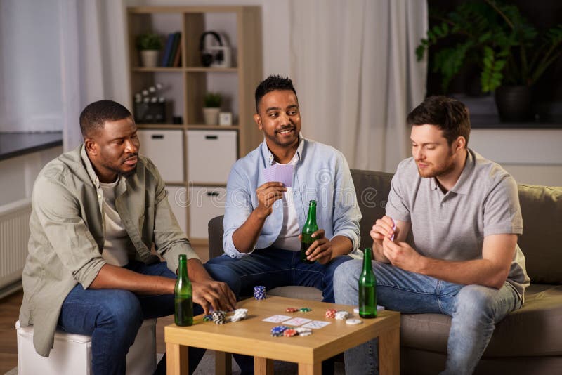 Amigos Homens Felizes Jogando Cartas Em Casa à Noite Foto de Stock