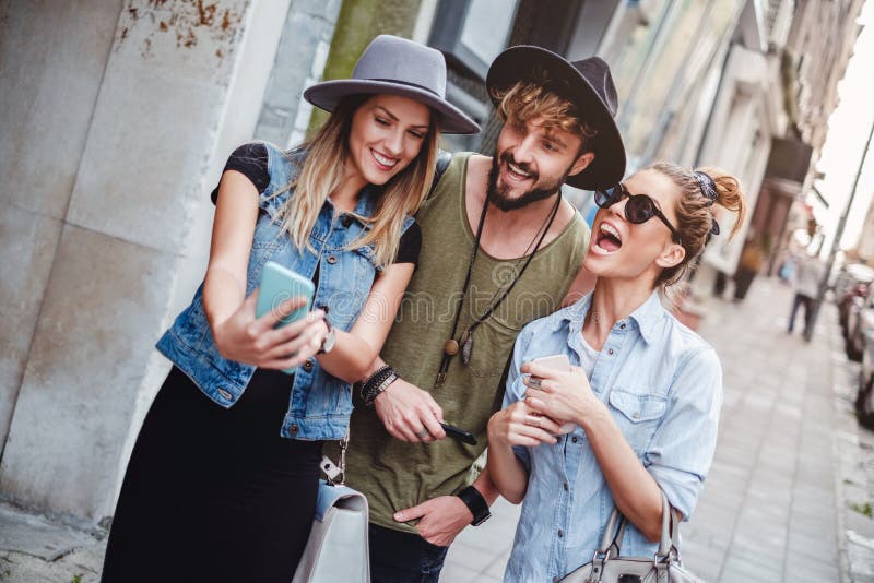 Amigos que toman el selfie en la calle y la risa imagen de archivo Amigos que toman el selfie en la calle y la risa imagen de archivo