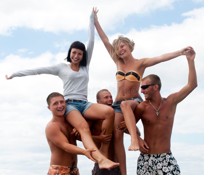Amigos que têm o divertimento na praia foto de stock Amigos que têm o divertimento na praia foto de stock