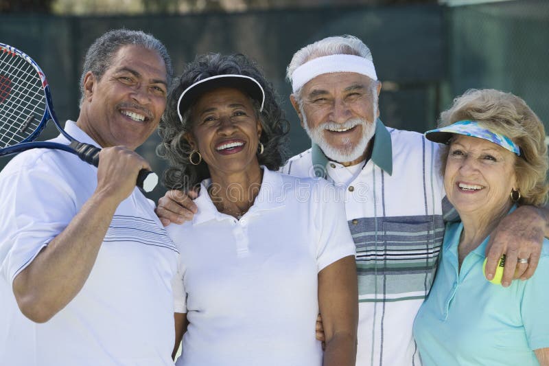 Portrait of happy senior friends in sportswear at tennis court. Portrait of happy senior friends in sportswear at tennis court