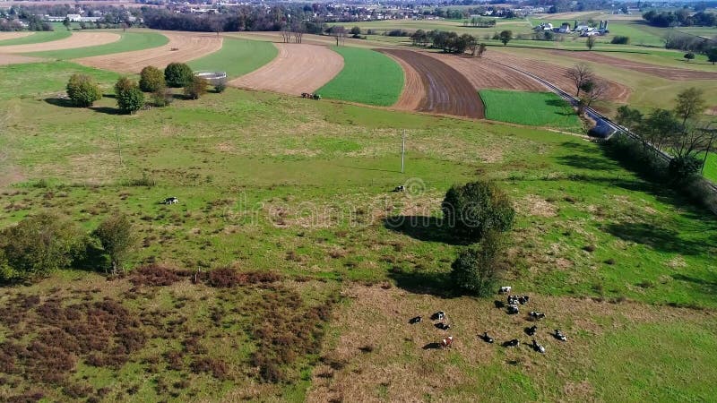 Amish farm workers organically fertilizing there fields as seen by a drone stock video footage