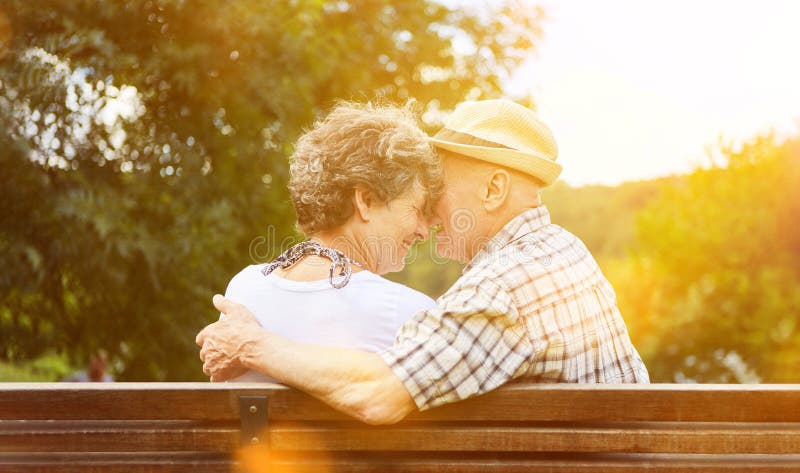 Amorous couple of seniors in the autumn in the park