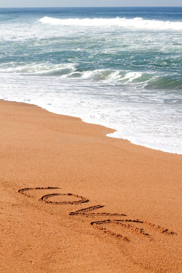 The word love written on the sand on the beach. The word love written on the sand on the beach