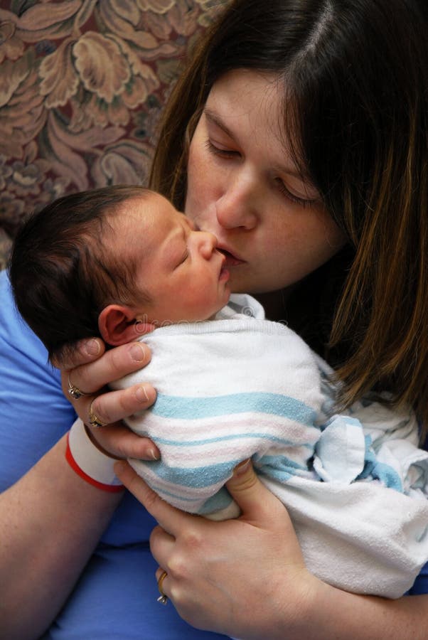 A mother at the birthing center loving on her newborn. A mother at the birthing center loving on her newborn.