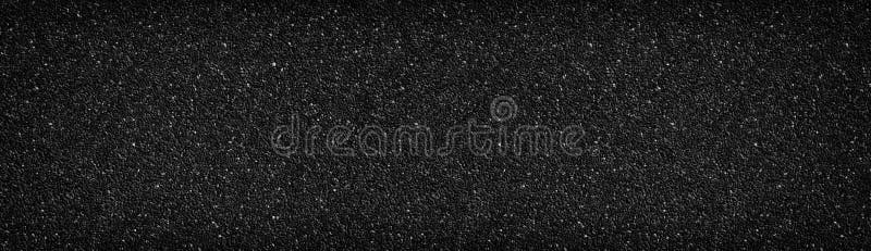 Ampia struttura nera della parete di pietra Superficie antracite Fondo panoramico scuro del un poco di ciottolo immagini stock Ampia struttura nera della parete di pietra Superficie antracite Fondo panoramico scuro del un poco di ciottolo immagini stock