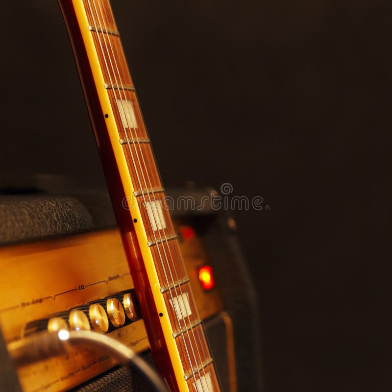 Amplificateur combiné pour la guitare électrique avec le cou de guitare sur le fond noir Profondeur de champ, discrète, fin Foye photos libres de droits Amplificateur combiné pour la guitare électrique avec le cou de guitare sur le fond noir Profondeur de champ, discrète, fin Foye photos libres de droits