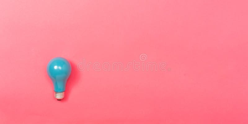 Colored light bulb on a pink paper background. Colored light bulb on a pink paper background