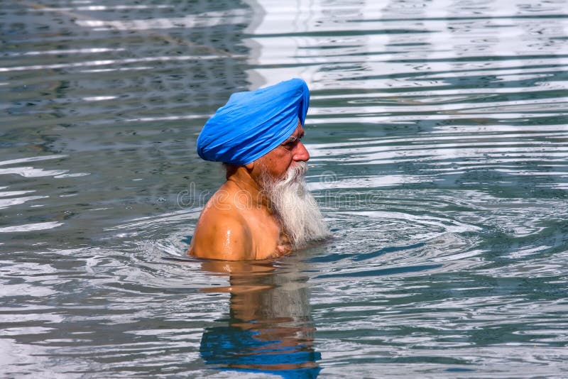 AMRITSAR, INDIA - OCTOBER 18: Unidentified Sikh visiting the Golden Temple in October 18, 2012 in Amritsar, Punjab, India. Sikh pilgrims travel from all over India to pray at this holy site. AMRITSAR, INDIA - OCTOBER 18: Unidentified Sikh visiting the Golden Temple in October 18, 2012 in Amritsar, Punjab, India. Sikh pilgrims travel from all over India to pray at this holy site.