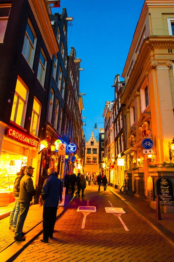 AMSTERDAM-APRIL 27: Nightlife on Amsterdam narrow street in red light district on April 27,2015, the Netherlands.