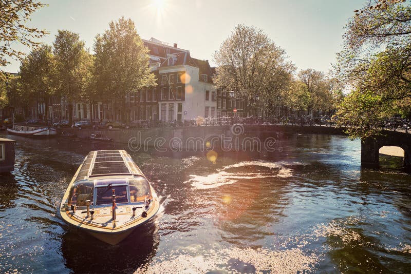 Amsterdam canal with tourist boat