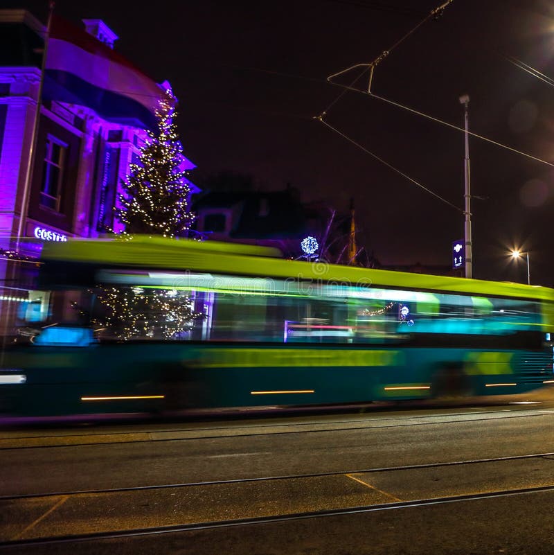 Amsterdam city road with different kinds moving transport at night.