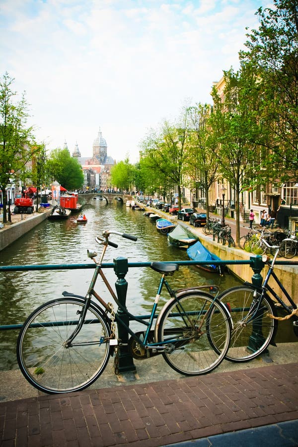 Amsterdam canal lined with boats and bicycles. Amsterdam canal lined with boats and bicycles.