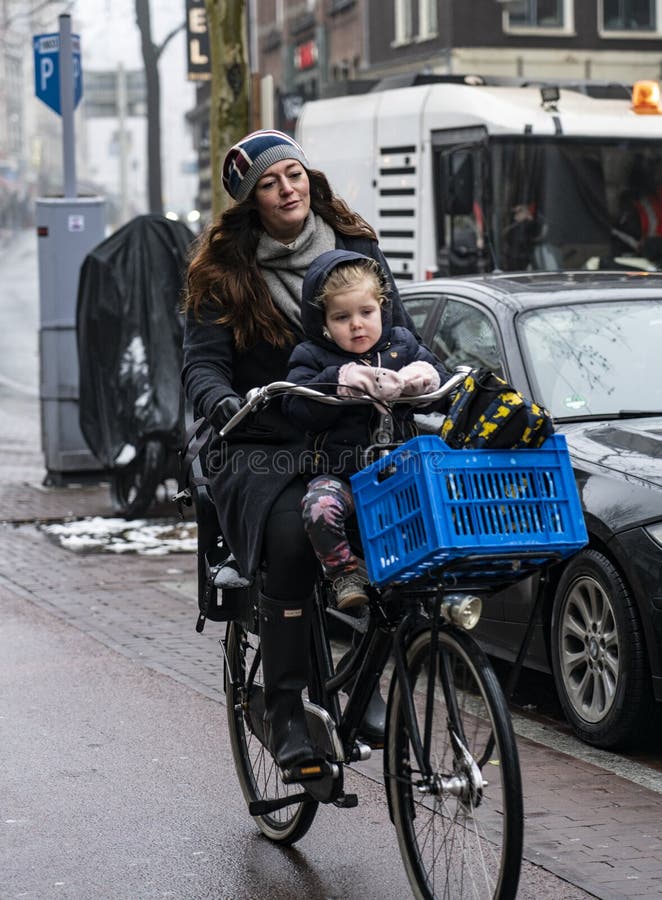 Amsterdam Holland Between the alleys of the city it is normal to meet families by bike The bicycle is the most used means by many people to get around the city every day Bicycles are used more than the car and is a famous Dutch feature in the world. Amsterdam Holland Between the alleys of the city it is normal to meet families by bike The bicycle is the most used means by many people to get around the city every day Bicycles are used more than the car and is a famous Dutch feature in the world