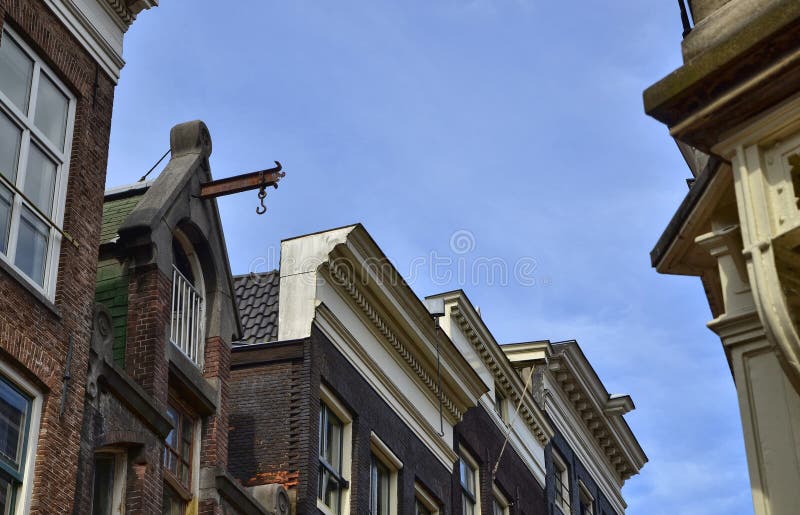 Amsterdam, Holland. August 2019. Detail of the top of the facade of a typical house in the center, a beam protrudes from the roof