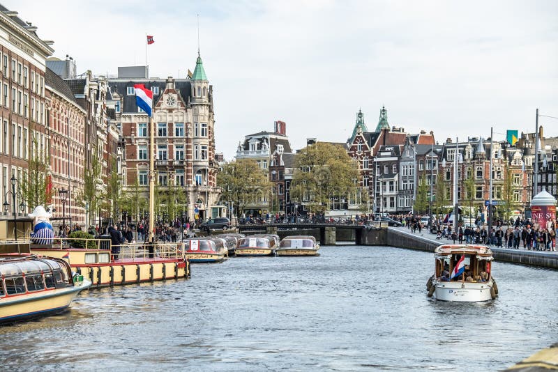 Amsterdam Nederländerna - April 31, 2017: Fartyg som kör på kanalerna av Amterdam arkivbild Amsterdam Nederländerna - April 31, 2017: Fartyg som kör på kanalerna av Amterdam arkivbild
