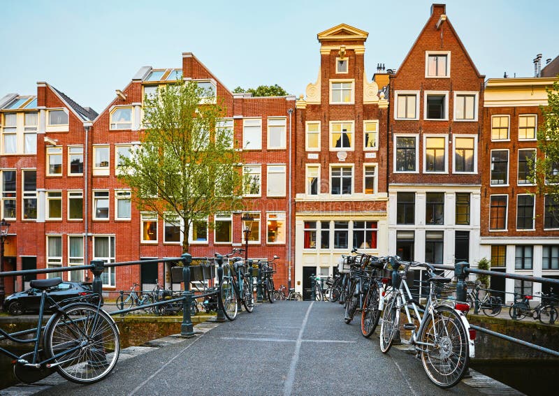 Amsterdam, Netherlands. Bridge with Bicycles and Houses Stock Photo