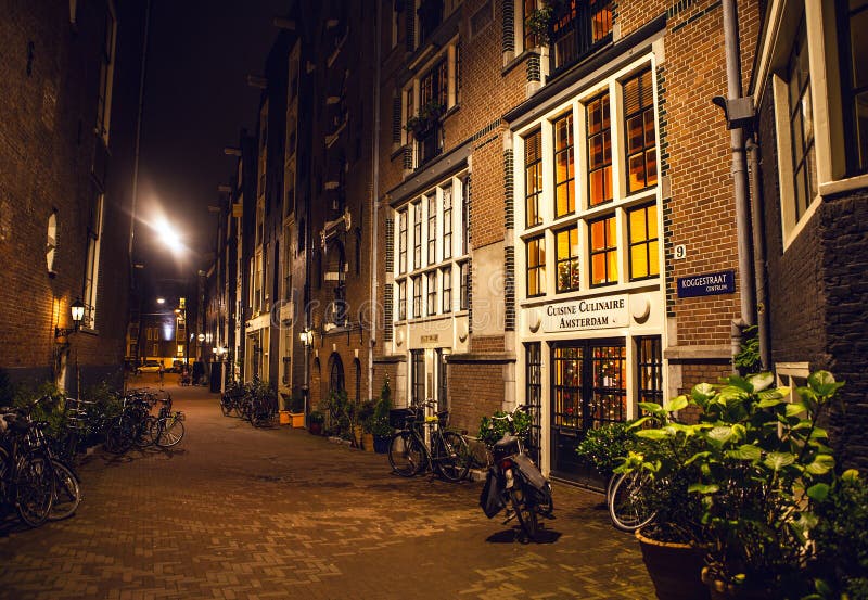 AMSTERDAM, NETHERLANDS - JANUARY 22 2016: City streets of Amsterdam at night. General views of city landscape on January 22, 2016