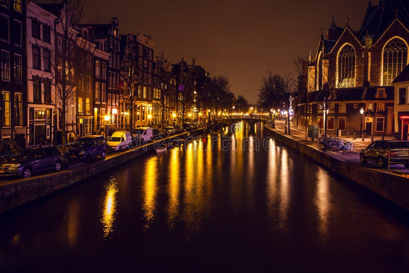 AMSTERDAM, NETHERLANDS - JANUARY 22 2016: City streets of Amsterdam at night. General views of city landscape on January 22, 2016