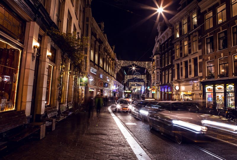 AMSTERDAM, NETHERLANDS - JANUARY 22 2016: City streets of Amsterdam at night. General views of city landscape on January 22, 2016